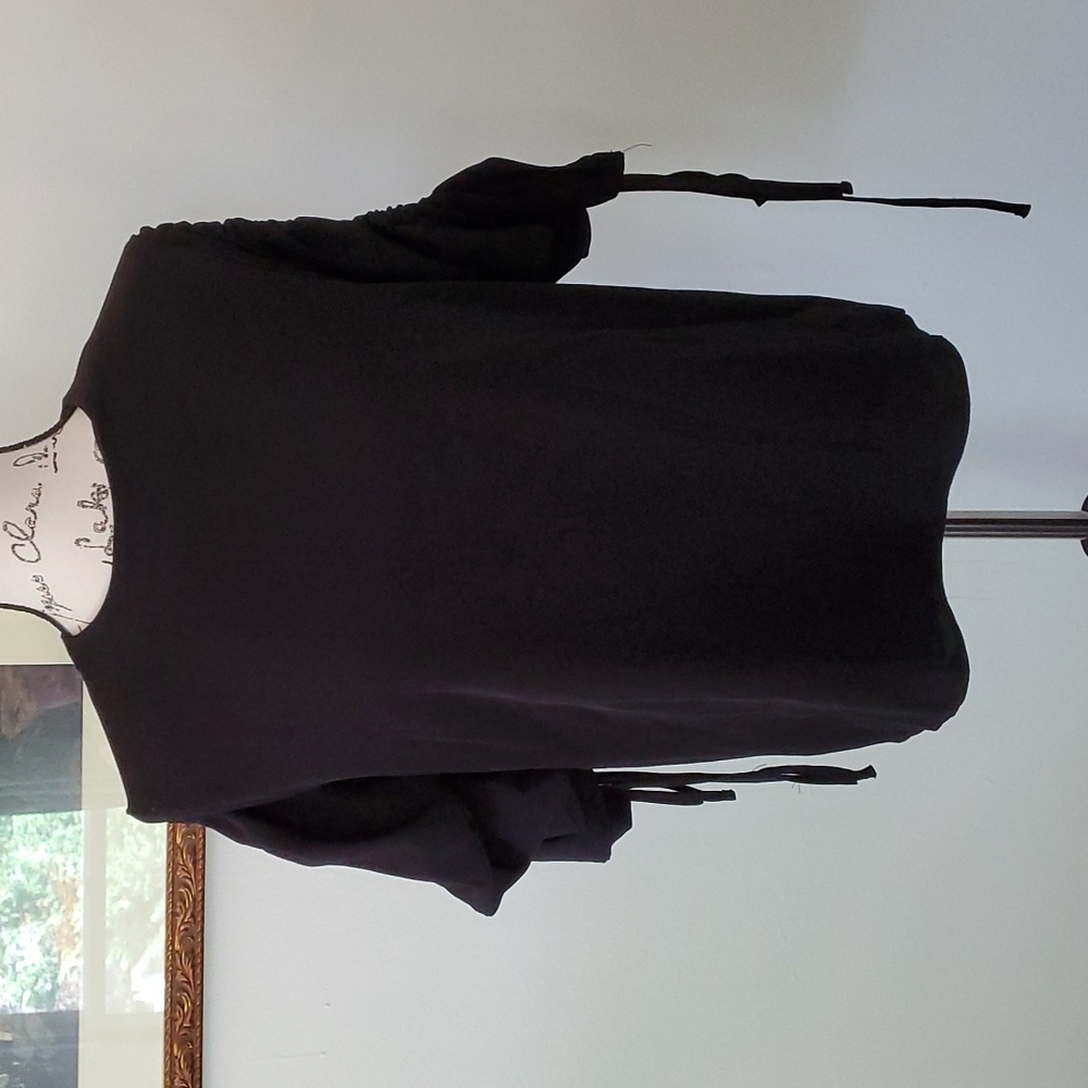 May May, black top with large, gathered sleeves.